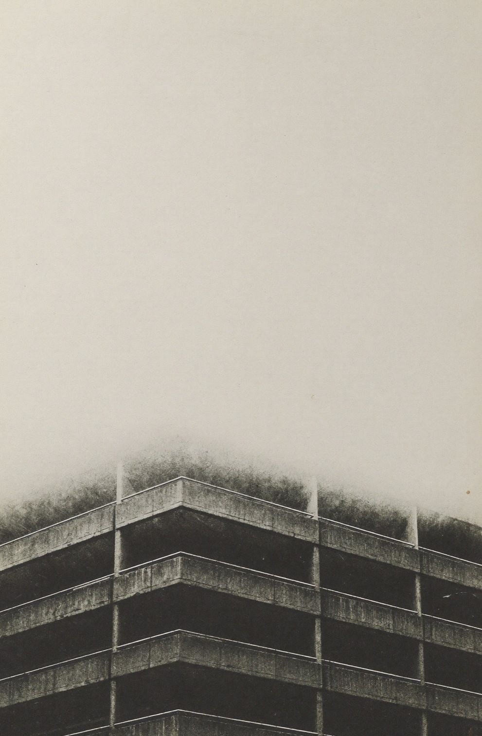 Concrete housing block receding into fog