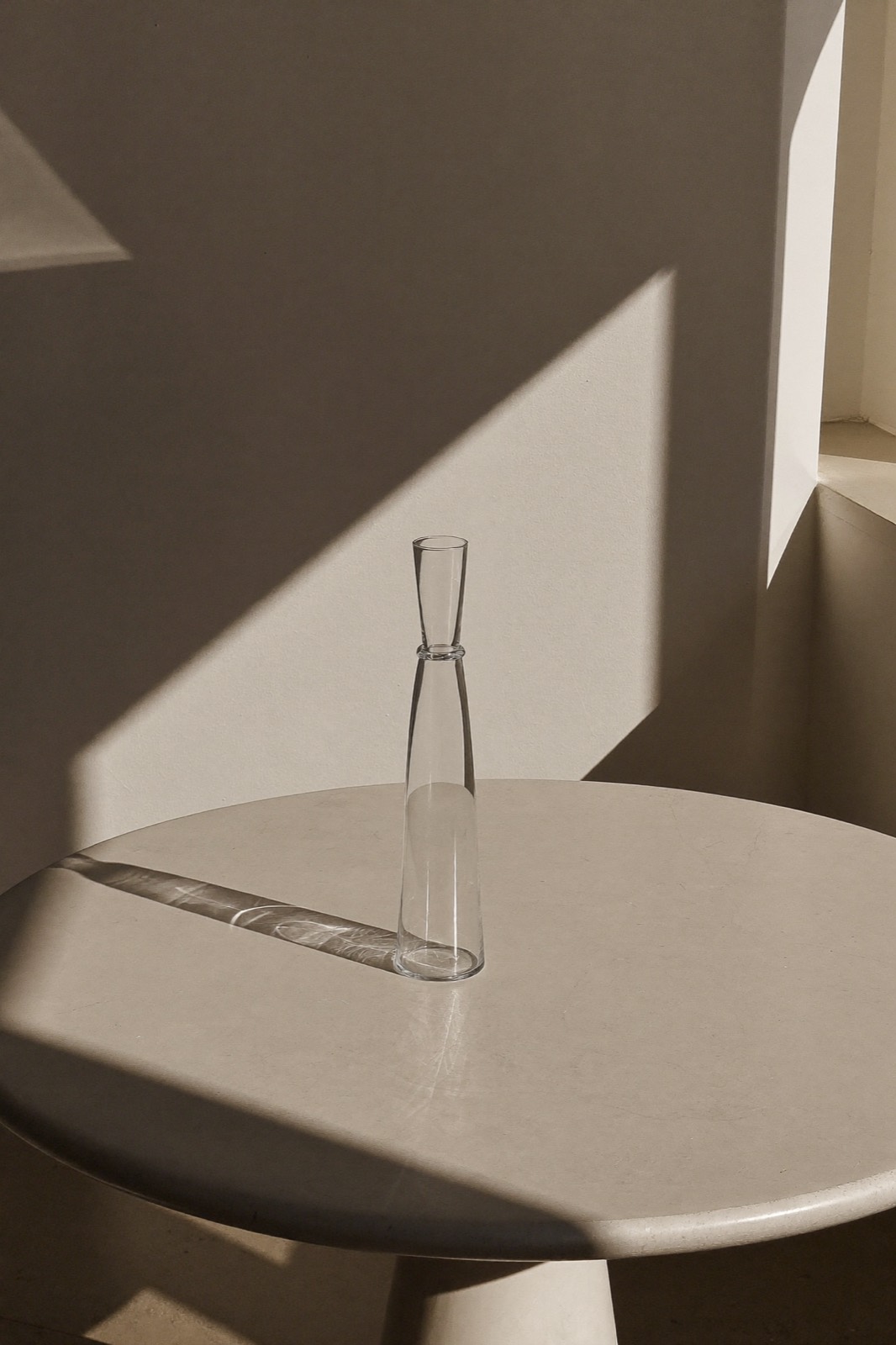 Glass vessel casting refractions in raking light